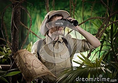 Explorer in the jungle with binoculars Stock Photo