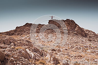 Exploring - lonely human walking in a rocky desert freedom and adventure lifestyle and sport concepts Stock Photo