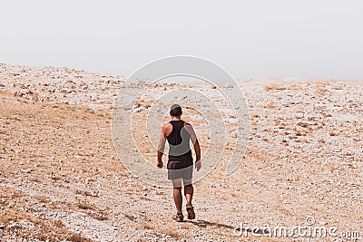 Exploring - lonely human walking in a rocky desert freedom and adventure lifestyle and sport concepts Stock Photo