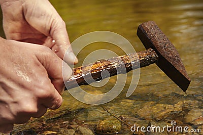 Exploring of river with magnet on rope and finding of hammer Stock Photo