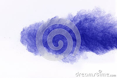 The explosion of blue colored powder. Freeze motion of color powder exploding on white background. Stock Photo