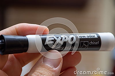 Expo Dry Erase marker, black, with hand holding for whiteboards. Mistakes, remove, education concepts Editorial Stock Photo