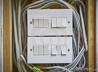 Modern wall light switches with all their wires exposed Stock Photo