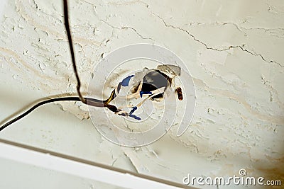 Old, unsafe wiring in the apartment. Safety violation Stock Photo