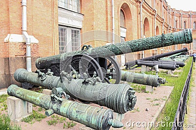 Exposition of ancient trunks and guns. Editorial Stock Photo