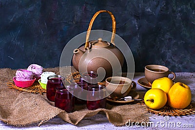 Exposition of hand made clay set on white wooden table and dark background, with tasty chocolate cake, nature fresh jelly, marshma Stock Photo