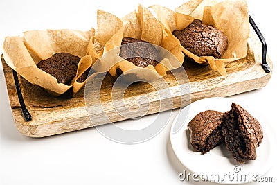 Exposition of very tasty chocolate cake with soft inside in wooden plate on white background,perfect desert with tea. Stock Photo