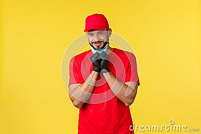 Express delivery during pandemic, covid-19, safe shipping, online shopping concept. Cute bearded courier with lovely Stock Photo