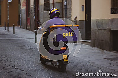 Express service, delivery company Getit. Stuart courier rides scooter food order Editorial Stock Photo
