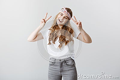 Expressing positive emotions. Portrait of charming sincere caucasian female model in stylish clothes and bright headband Stock Photo