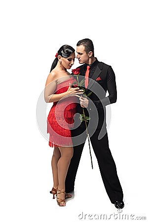 Expressive, elegant dancer gifting red rose to attractive, sensual partner Stock Photo