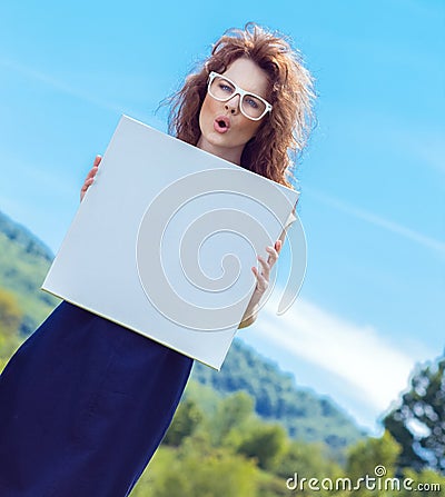 Expressive funny woman holding white board Stock Photo