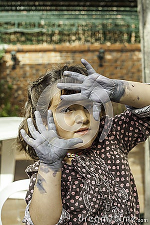 Expressive girl portrait acting with painted hands Stock Photo