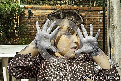 Expressive girl portrait acting with painted hands Stock Photo