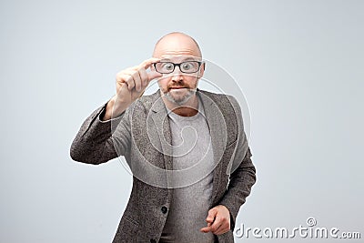 Funny middle aged man looking through glasses. His eyes are big. Stock Photo