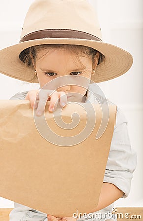 Expressive little girl reading tresure map Stock Photo