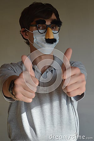 Man wearing face mask and Groucho glasses Stock Photo