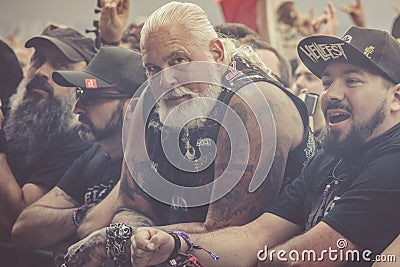 Expressive old metalhead first line in a concert Editorial Stock Photo