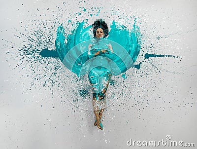 expressive sexy woman lies naked elegant on the floor in turquoise blue color abstract painted bodypainting woman on the splashed Stock Photo