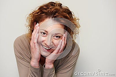 Expressive woman holding head in hands in surprise Stock Photo