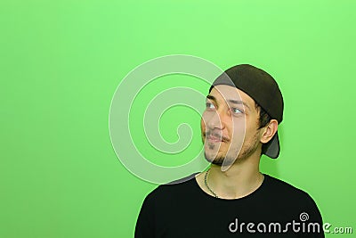 Expressive young man or guy on a light green background. The emotion of modesty Stock Photo
