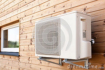 Exterior airconditioning unit on a wooden wall. Stock Photo