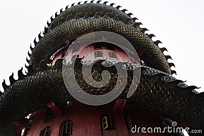 Exterior building with king of serpent naga and chinese dragon wrapped around tower for thai people travel visit and respect Stock Photo