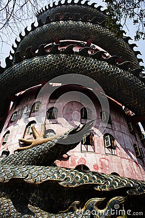 Exterior building with king of serpent naga and chinese dragon wrapped around tower for thai people travel visit and respect Stock Photo