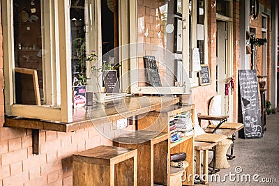 Exterior facade of a loft cafe with wooden recycled furniture for coworking Editorial Stock Photo