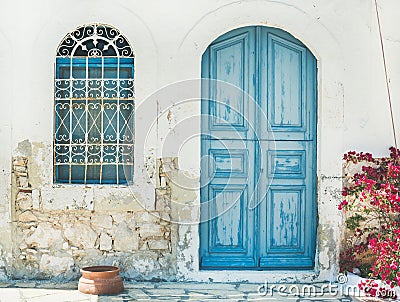 Exterior of Greek island traditional street with blue door, Kast Stock Photo