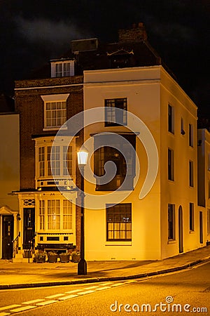 the exterior of a home from the 1700's lit by a street lamp in Old portsmouth, Portsmouth, UK Stock Photo