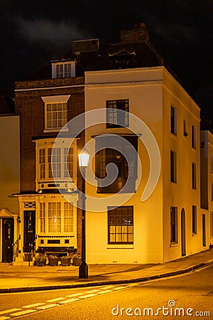 the exterior of a home from the 1700's lit by a street lamp in Old portsmouth, Portsmouth, UK Editorial Stock Photo