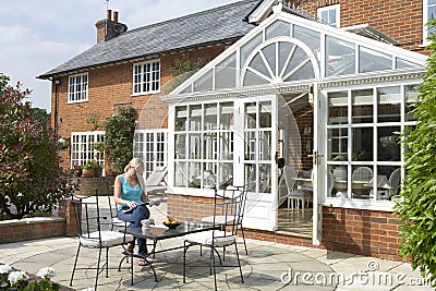 Exterior Of House With Conservatory And Patio Stock Photo