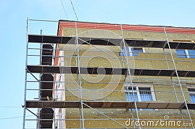 Exterior house wall heat insulation with mineral wool, building under construction. Stock Photo