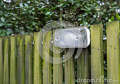 Exterior light mounted on wooden fence Stock Photo