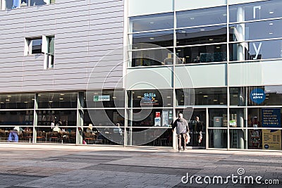 Exterior of Newcastle City Library building showing man entering through entrance door Editorial Stock Photo