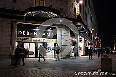 Exterior Night Shot of Illuminated entrance to Debenhams Department Store with Patisserie Valerie sign Editorial Stock Photo