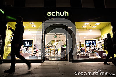 Exterior Night Shot of Illuminated entrance to Schuh Footware store Editorial Stock Photo