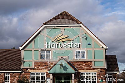 Exterior outside shot of Harvester Family Restaurant Pub Chain showing entrance and company sign and logo Editorial Stock Photo