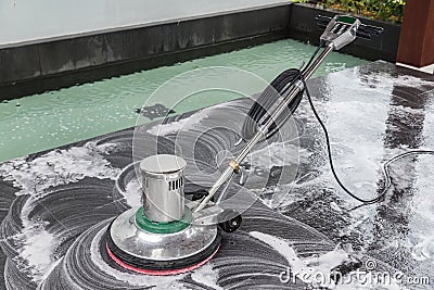 Exterior stone floor cleaning with polishing machine and chemica Stock Photo