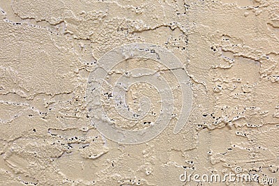 Exterior Tan Wall with Rough Stucco and Holes Texture Stock Photo
