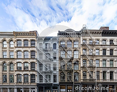 Exterior view of old apartment buildings in the SoHo neighborhood of Manhattan in New York City with empty blue sky Stock Photo