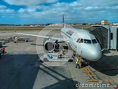 Exterior view of the runway and lift and maintenance of aircraft at Lisbon airport with airplanes and cargo Editorial Stock Photo