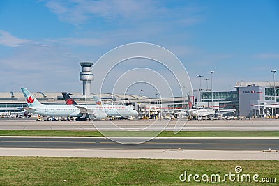 Exterior view of the Toronto Pearson International Airport and Air Canada airplane Editorial Stock Photo