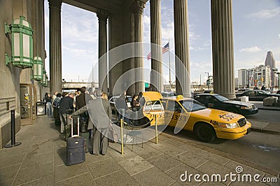 Exterior view of yellow taxi cab in front of the 30th Street Station, a national Register of Historic Places, AMTRAK Train Statio Editorial Stock Photo