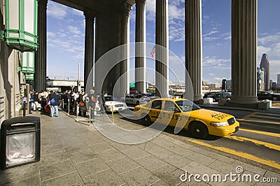 Exterior view of yellow taxi cab in front of the 30th Street Station, a national Register of Historic Places, AMTRAK Train Statio Editorial Stock Photo