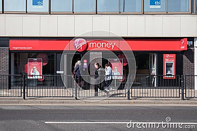 Exterior of Virgin Money branch on a high street with people walking past and customers using entrance Editorial Stock Photo