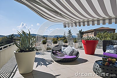 Exteriors shots of a modern terrace with awnings and sofas Stock Photo