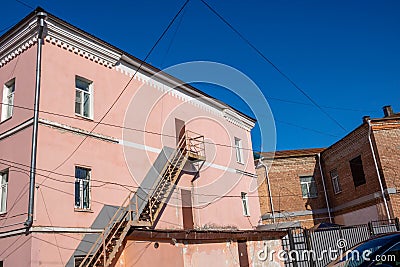 External staircase on the facade of the building. Fire escape in the open air. Emergency ladder Stock Photo