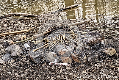 Extinguished fire beside a river Stock Photo
